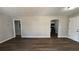 Open-concept living room with wood flooring and a view into the updated kitchen at 110 Raymond St, Jonesboro, GA 30236