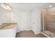 Bathroom featuring a vanity with a granite countertop and tiled shower at 11844 Rizvan Pl, Covington, GA 30014