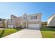 Attractive two-story home with a brick and siding facade and a long driveway at 11844 Rizvan Pl, Covington, GA 30014