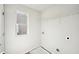 Bright laundry room boasts shelving and utility hookups at 11844 Rizvan Pl, Covington, GA 30014