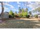 Landscaped backyard with lush trees and greenery, offering a serene and private outdoor space at 1897 De Winton Pl, Lawrenceville, GA 30043