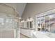 Modern bathroom featuring double vanity, a soaking tub, and a glass enclosed shower at 1897 De Winton Pl, Lawrenceville, GA 30043