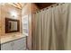 A cozy, finished basement bathroom featuring a shower, vanity, decorative mirror, and neutral decor at 1897 De Winton Pl, Lawrenceville, GA 30043