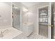 Neutral bathroom showcasing a walk-in shower, double sinks, and a clear view into an additional bedroom at 1897 De Winton Pl, Lawrenceville, GA 30043