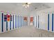 Cozy bedroom featuring vaulted ceilings, blue striped walls and playful painted details throughout at 1897 De Winton Pl, Lawrenceville, GA 30043