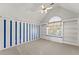 Bright bedroom featuring blue striped walls, built-in shelving and a charming window seat with natural light at 1897 De Winton Pl, Lawrenceville, GA 30043