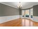 Formal dining room featuring classic wainscoting, hardwood floors, and large windows at 1897 De Winton Pl, Lawrenceville, GA 30043