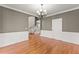 Formal dining room featuring classic wainscoting and hardwood floors, with access to the stairwell at 1897 De Winton Pl, Lawrenceville, GA 30043