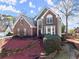 Lovely two-story brick home with well-kept lawn and mature landscaping at 1897 De Winton Pl, Lawrenceville, GA 30043