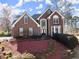 Charming two-story brick home with manicured front yard and arched windows at 1897 De Winton Pl, Lawrenceville, GA 30043