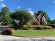 Two-story brick home with meticulous landscaping and a lush green lawn at 1897 De Winton Pl, Lawrenceville, GA 30043