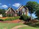 Beautiful brick home featuring manicured lawn and well-maintained landscaping at 1897 De Winton Pl, Lawrenceville, GA 30043