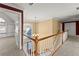 Hallway with wooden banister and natural light leads to bedrooms at 1897 De Winton Pl, Lawrenceville, GA 30043