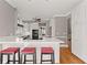 Bright kitchen with white cabinets, stainless steel appliances, and a countertop with barstool seating at 1897 De Winton Pl, Lawrenceville, GA 30043