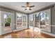 Bright sunroom with hardwood floors, large windows, and access to the deck at 1897 De Winton Pl, Lawrenceville, GA 30043