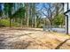 Backyard featuring a deck and a dirt lot, partially wooded, and backing up to mature trees at 658 Woods Dr, Atlanta, GA 30318