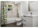 Bathroom features a shower-tub combination, toilet, and modern vanity sink at 658 Woods Dr, Atlanta, GA 30318