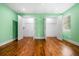 Bedroom features hardwood floors, closet doors, and light green walls at 658 Woods Dr, Atlanta, GA 30318