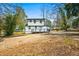 Exterior view of a two-story home with a deck and large backyard in need of landscaping at 658 Woods Dr, Atlanta, GA 30318