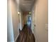 Hallway features gray wood floors and access to bathroom and other rooms at 8666 Webb Rd, Riverdale, GA 30274