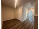 Hallway features modern gray wood floors and access to closets and other rooms at 8666 Webb Rd, Riverdale, GA 30274