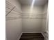 Walk-in closet with wire shelving and gray wood floors at 8666 Webb Rd, Riverdale, GA 30274