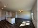 Bright living room and kitchen featuring an island with granite countertops and stainless steel sink at 8668 Webb Rd, Riverdale, GA 30274