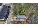 An aerial view of a blue two-story home showcasing its backyard, adjacent to newly built townhomes, and landscaped front yard at 1889 Felker Ward Nw St, Atlanta, GA 30318