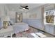 Bright bedroom featuring stylish patterned rug, neutral walls and modern ceiling fan and wainscotting at 1889 Felker Ward Nw St, Atlanta, GA 30318