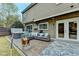 Charming backyard featuring a cozy outdoor seating area, hot tub, and view of the well-manicured lawn at 245 Davenham Ct, Alpharetta, GA 30005