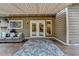 Backyard patio featuring a patio rug, awning, and access to the house through French doors at 245 Davenham Ct, Alpharetta, GA 30005