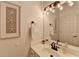 Charming bathroom with decorative starfish art, a white vanity, and a well-lit mirror at 245 Davenham Ct, Alpharetta, GA 30005