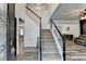 Bright foyer with a grand staircase, featuring wood-look floors and elegant wainscoting at 245 Davenham Ct, Alpharetta, GA 30005