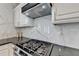 Updated kitchen featuring stainless steel appliances, gas range, marble backsplash, and granite countertops at 245 Davenham Ct, Alpharetta, GA 30005