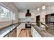 Kitchen featuring stainless steel appliances, gas range, marble backsplash, granite countertops, and white cabinets at 245 Davenham Ct, Alpharetta, GA 30005