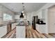 Modern kitchen featuring white cabinets, stainless steel appliances, marble backsplash, and hardwood style floors at 245 Davenham Ct, Alpharetta, GA 30005