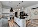 Kitchen featuring white cabinets, stainless steel appliances, marble backsplash, granite countertops and center island at 245 Davenham Ct, Alpharetta, GA 30005