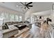 Open living room with view to dining area and kitchen featuring hardwood style floors, vaulted ceiling, and ceiling fan at 245 Davenham Ct, Alpharetta, GA 30005