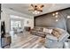 Comfortable living room featuring updated flooring, a ceiling fan and a sectional sofa at 245 Davenham Ct, Alpharetta, GA 30005