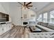 Spacious living room featuring a fireplace, large sectional, and plenty of natural light at 245 Davenham Ct, Alpharetta, GA 30005