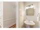 A bathroom with a white pedestal sink and decorative mirror at 111 Paces Run, Atlanta, GA 30339