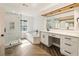 Elegant bathroom featuring a soaking tub, glass shower, wood plank accent, and modern white vanity at 111 Paces Run, Atlanta, GA 30339