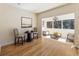 Bright dining area features hardwood floors, modern lighting, and scenic views from the adjacent sitting room at 111 Paces Run, Atlanta, GA 30339
