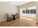 Open dining area with hardwood floors, a modern chandelier, and natural light from the surrounding windows at 111 Paces Run, Atlanta, GA 30339