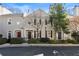 Exterior view of townhome with gray facade, well-maintained landscaping, and a red front door at 111 Paces Run, Atlanta, GA 30339