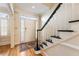Welcoming front entryway featuring wood floors, stairs with black trim and sidelight windows at 111 Paces Run, Atlanta, GA 30339