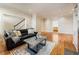 Spacious living room flowing into dining area with hardwood floors, detailed trim and neutral paint at 111 Paces Run, Atlanta, GA 30339