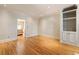 Spacious living room features hardwood floors, built-in shelving, and an open doorway to the kitchen at 111 Paces Run, Atlanta, GA 30339