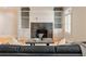 Cozy living room with a fireplace, built-in shelving, hardwood floors, and comfortable seating at 111 Paces Run, Atlanta, GA 30339