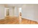 Spacious living room has hardwood floors, neutral paint, and a glimpse into the adjoining kitchen at 111 Paces Run, Atlanta, GA 30339